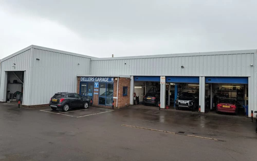 Dellers Garage on Hobley Drive, Swindon — the reception under the DVSA MOT sign and three open workshop bays